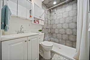 Full bathroom with vanity and tiled shower