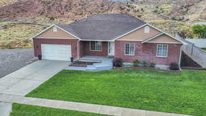 Ranch-style home with brick siding, a garage, concrete driveway, and roof with shingles