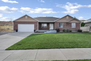 Ranch-style home featuring brick siding, an attached garage, concrete driveway, and a shingled roof