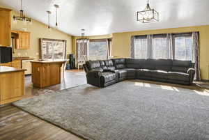 Living area featuring a chandelier and lofted ceiling