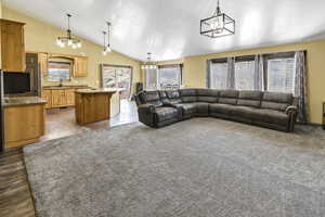 Living area featuring a chandelier and lofted ceiling