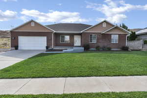 Ranch-style home with brick siding, a garage, concrete driveway, and a shingled roof