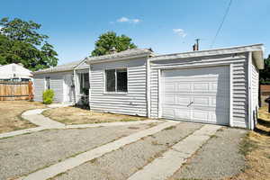 Ranch-style house with a garage, roof with shingles, and driveway