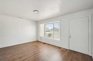 Foyer entrance featuring wood finished floors