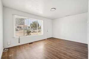 Spare room featuring baseboards and wood finished floors