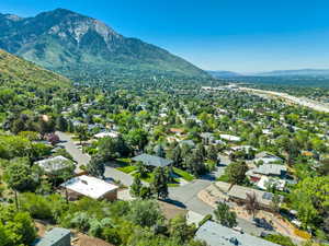 View of property location featuring mountains and nearby suburban area