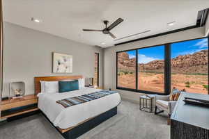 Bedroom featuring carpet flooring, ceiling fan, and a mountain view