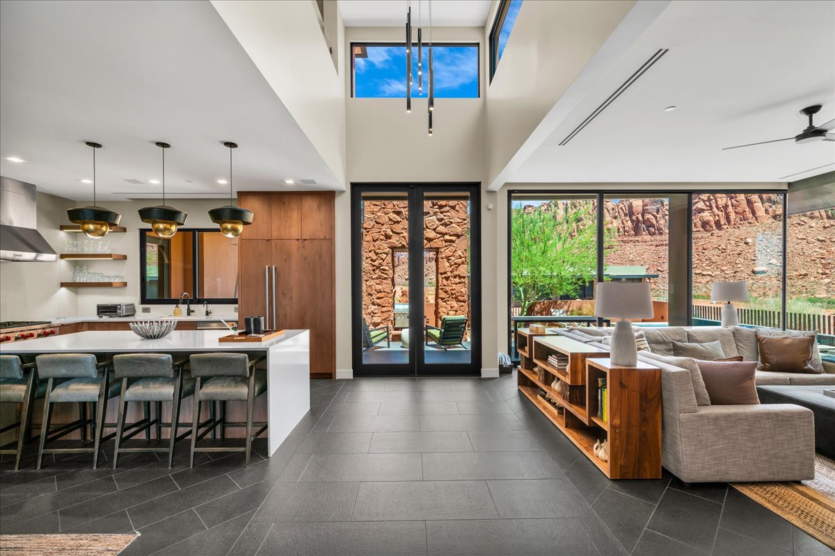 Living area featuring dark tile patterned flooring and recessed lighting