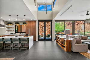 Living area featuring dark tile patterned flooring and recessed lighting