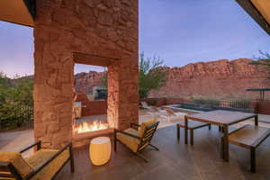 Patio terrace at dusk with an outdoor fire pit and a patio area