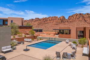 Outdoor pool featuring an outdoor living space, a patio area, and a mountain view