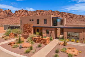 Pueblo revival-style home with stucco siding and a mountain view