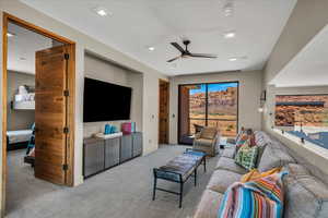 Living room with ceiling fan and carpet floors