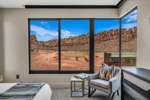 Carpeted bedroom with a mountain view and baseboards