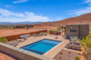 View of swimming pool featuring a patio area, a mountain view, and a grill