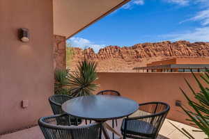Balcony featuring outdoor dining area and a mountain view