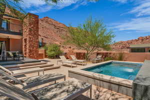 View of pool with a fenced backyard, a patio area, and a mountain view
