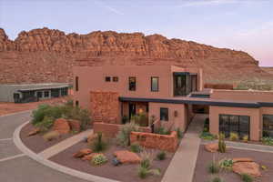 View of front of property with stucco siding and a mountain view