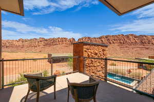 Balcony featuring view of pool