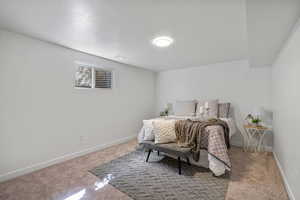 Bigger bedroom with walk-in closet  featuring carpet, baseboards and a textured ceiling