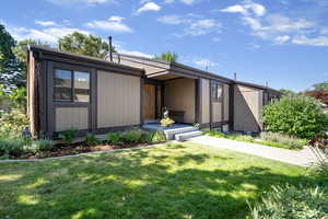 Mid-century inspired home with a front lawn