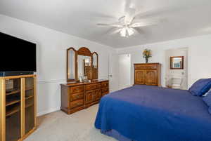 Huge Primary Bedroom with light carpet, a ceiling fan, and a textured ceiling
