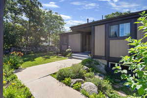 View of exterior entry featuring a yard