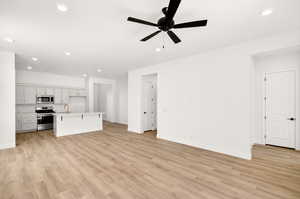 Unfurnished living room with light wood-style flooring, recessed lighting, and ceiling fan