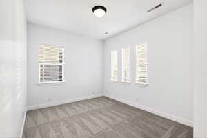 Empty room with carpet floors and baseboards