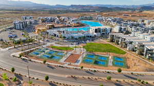 Aerial view of property and surrounding area featuring a mountainous background and a pool