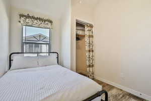 Bedroom with wood finished floors and baseboards