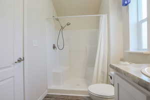Bathroom featuring curtained shower and vanity