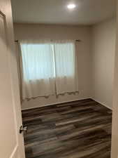 Unfurnished room featuring dark wood-style floors and recessed lighting
