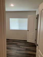 Spare room with dark wood-style floors, healthy amount of natural light, and recessed lighting