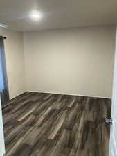 Spare room with dark wood finished floors