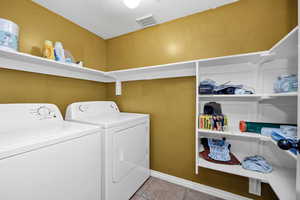 Laundry area with independent washer and dryer and baseboards