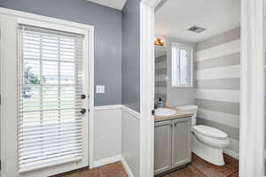 Half bathroom featuring vanity and tile patterned floors