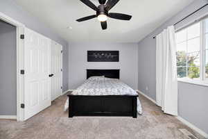 Carpeted bedroom with baseboards and ceiling fan