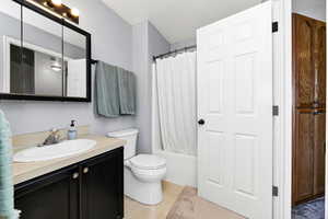 Bathroom with vanity and shower / bathtub combination with curtain