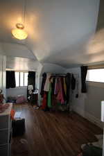 743-Bedroom with wood finished floors and lofted ceiling