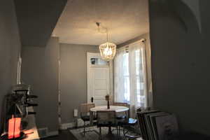 745-Dining area with a chandelier and a textured ceiling