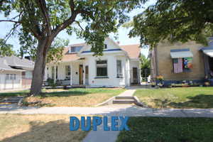 View of front of home with a porch and a front lawn