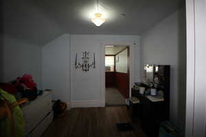 743-Bedroom featuring wood finished floors and baseboards
