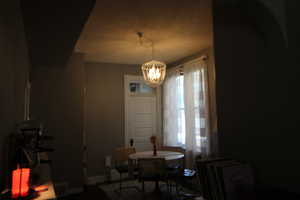 745-Dining area featuring a chandelier and baseboards