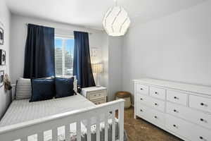 Bedroom featuring dark carpet