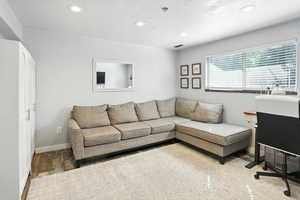 Living room with recessed lighting and wood finished floors