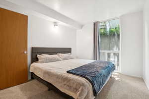 Carpeted bedroom featuring baseboards