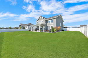 View of front of house with stucco siding, a fenced backyard, and a patio