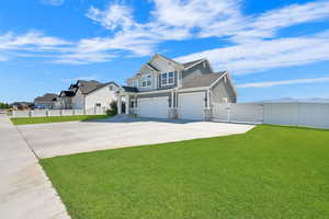 Craftsman house featuring a gate, stone siding, board and batten siding, concrete driveway, and an attached garage