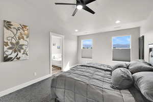 Bedroom featuring carpet floors, a ceiling fan, recessed lighting, and ensuite bathroom